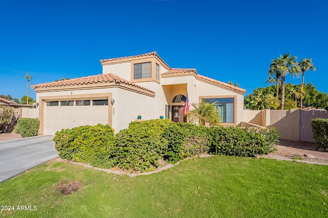 242 E Stonebridge Dr, Gilbert, AZ 85234 - mediterranean / spanish-style house featuring a garage, stucco siding, a tile roof, and driveway