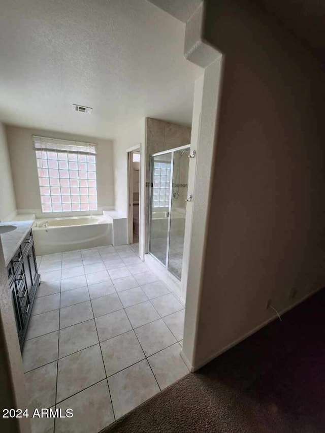 3853 W Calle Lejos, Glendale, AZ 85310 - bathroom featuring a stall shower, tile patterned floors, a bath, and plenty of natural light