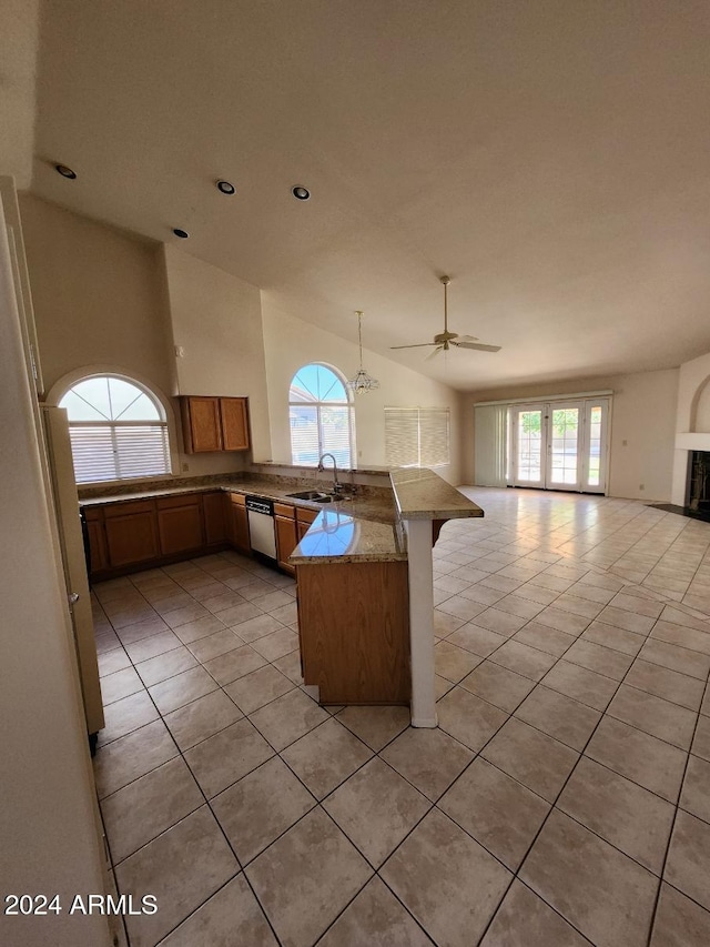 3853 W Calle Lejos, Glendale, AZ 85310 - kitchen with open floor plan, a peninsula, light tile patterned floors, vaulted ceiling, and plenty of natural light