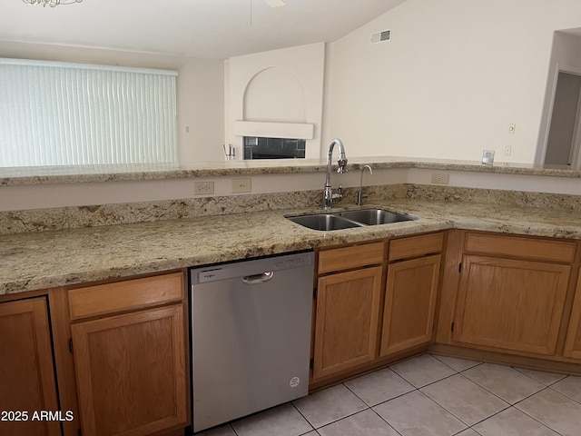 3853 W Calle Lejos, Glendale, AZ 85310 - kitchen featuring dishwasher, light tile patterned flooring, light stone counters, and brown cabinetry