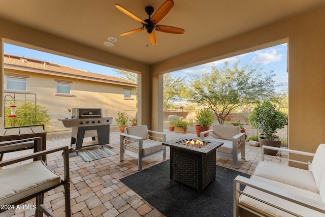 view of patio with grilling area, an outdoor living space with a fire pit, and ceiling fan