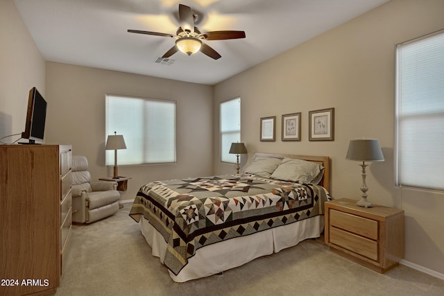 bedroom featuring ceiling fan and light carpet