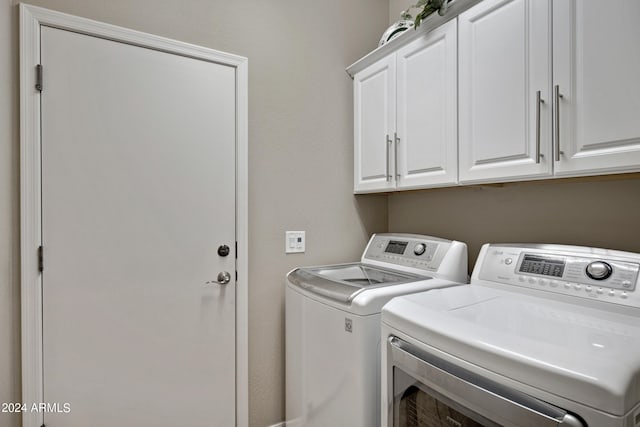 clothes washing area with cabinets and independent washer and dryer