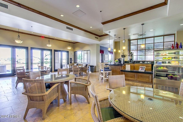 tiled dining area with crown molding and french doors