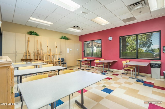 recreation room with a paneled ceiling