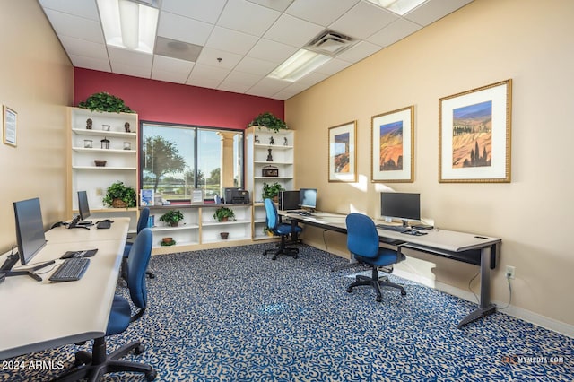 carpeted office featuring a drop ceiling