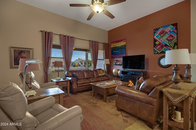 living room with a fireplace and ceiling fan