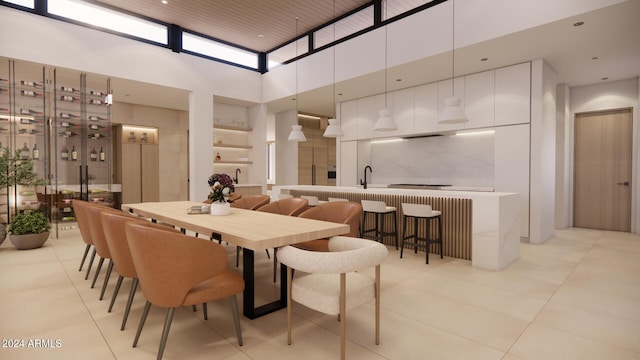 tiled dining room featuring a towering ceiling and sink