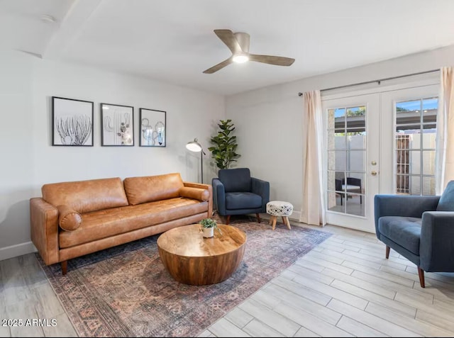 living room featuring ceiling fan, light hardwood / wood-style floors, and french doors