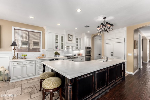 530 S Emerson St, Chandler, AZ 85225 - kitchen with arched walkways, appliances with stainless steel finishes, a sink, light countertops, and white cabinetry