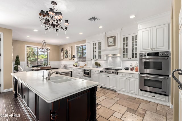 530 S Emerson St, Chandler, AZ 85225 - kitchen with stainless steel appliances, a chandelier, an island with sink, a sink, and white cabinets