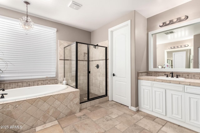 530 S Emerson St, Chandler, AZ 85225 - bathroom with a stall shower, a garden tub, vanity, stone tile floors, and tasteful backsplash