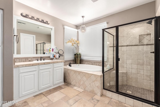 530 S Emerson St, Chandler, AZ 85225 - full bathroom with a garden tub, a stall shower, vanity, stone tile flooring, and a chandelier