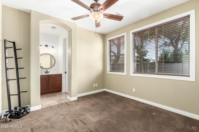 530 S Emerson St, Chandler, AZ 85225 - unfurnished bedroom with carpet floors, arched walkways, baseboards, ensuite bath, and a sink