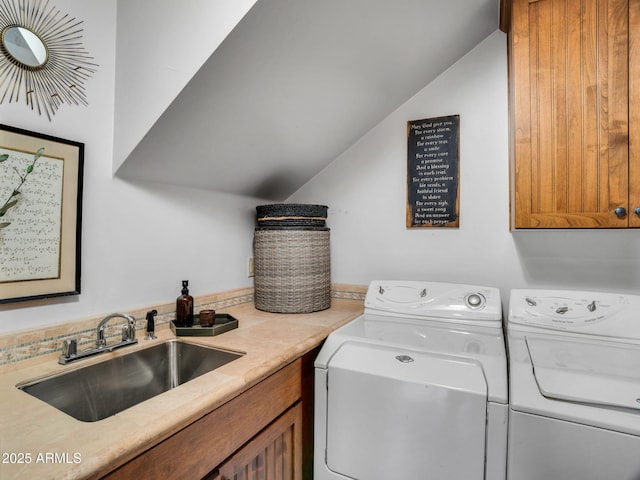 laundry room featuring a sink, washing machine and clothes dryer, and cabinet space