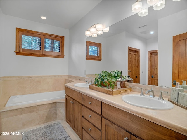 full bathroom featuring a garden tub, double vanity, and a sink
