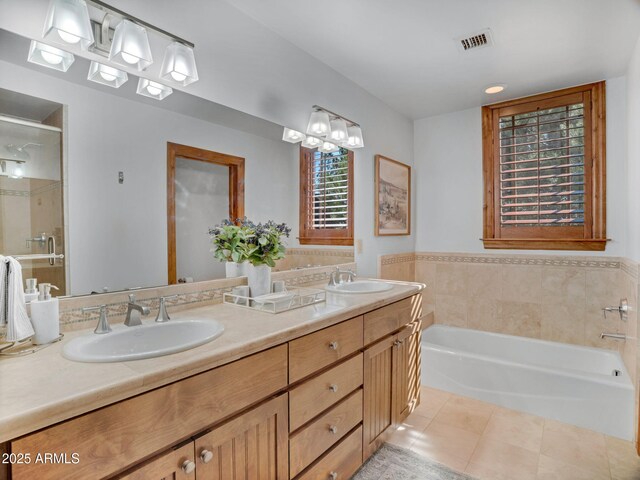 full bathroom featuring a bath, a sink, a stall shower, and visible vents