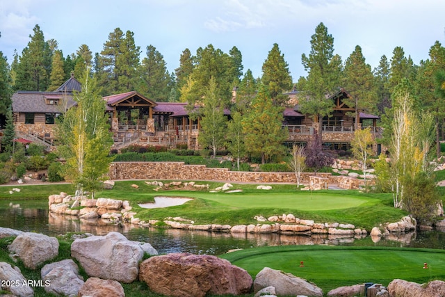 view of property's community featuring golf course view and a water view
