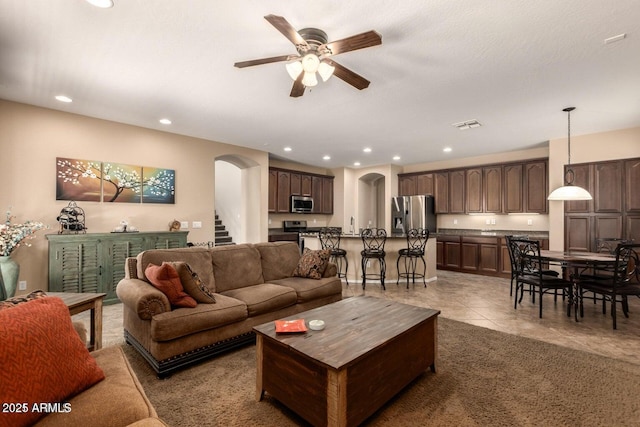 3693 E Sparrow Pl, Chandler, AZ 85286 - living room with arched walkways, a ceiling fan, recessed lighting, light tile patterned flooring, and stairway