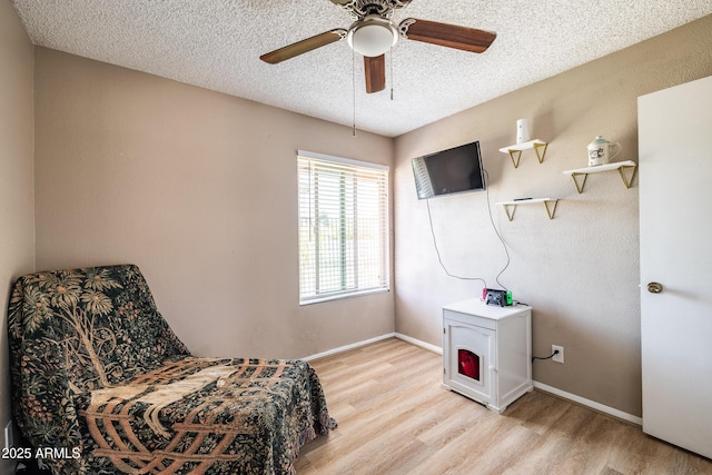 17802 N 45th Ave, Glendale, AZ 85308 - sitting room with baseboards, a ceiling fan, light wood finished floors, and a textured ceiling