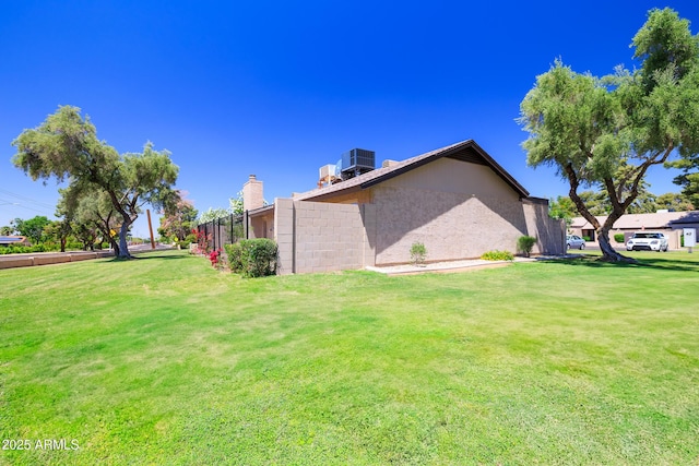 17802 N 45th Ave, Glendale, AZ 85308 - view of side of home featuring a lawn, fence, cooling unit, and a chimney