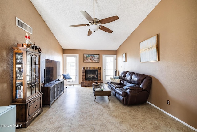 17802 N 45th Ave, Glendale, AZ 85308 - living area with ceiling fan, a fireplace with raised hearth, a textured ceiling, lofted ceiling, and visible vents