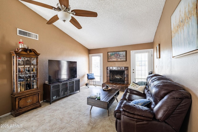 17802 N 45th Ave, Glendale, AZ 85308 - living area with a ceiling fan, a textured ceiling, visible vents, light tile patterned floors, and lofted ceiling