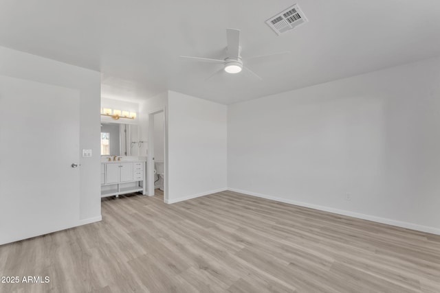 unfurnished bedroom with light wood-type flooring, ceiling fan, and sink