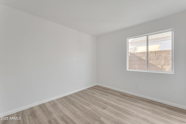 spare room featuring light wood-type flooring