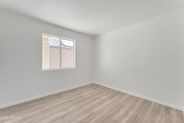 spare room with light hardwood / wood-style flooring