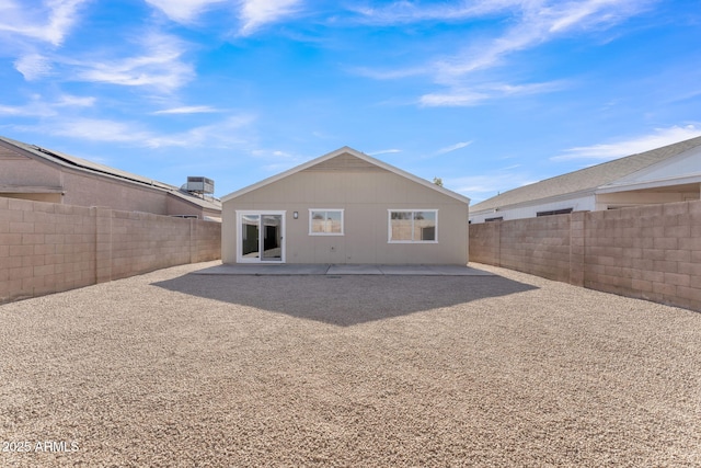 rear view of house with central air condition unit and a patio