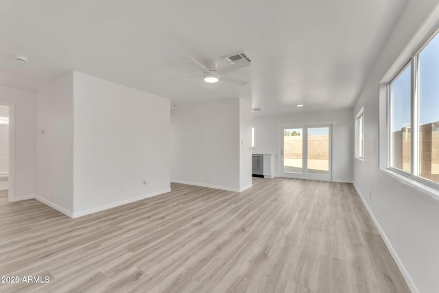 unfurnished living room featuring ceiling fan and light hardwood / wood-style floors