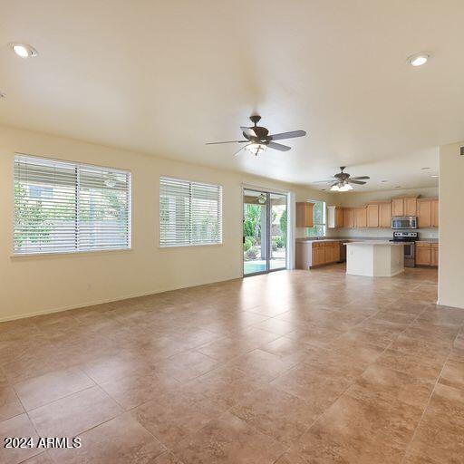 unfurnished living room featuring ceiling fan