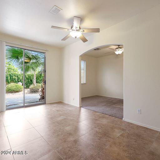 unfurnished room with ceiling fan and light colored carpet