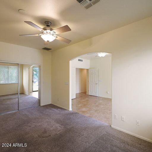 empty room featuring carpet and ceiling fan