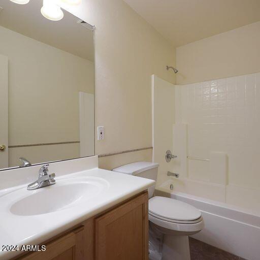 full bathroom with bathing tub / shower combination, vanity, and toilet