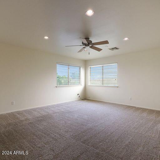 unfurnished room featuring carpet and ceiling fan