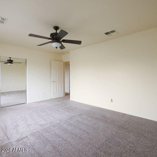 empty room featuring carpet and ceiling fan