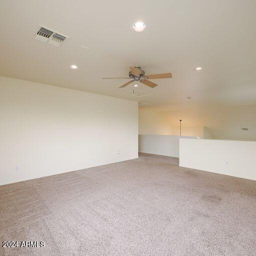 spare room with carpet and ceiling fan