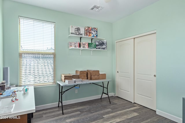 home office with dark hardwood / wood-style floors