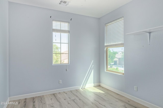 spare room with light hardwood / wood-style floors