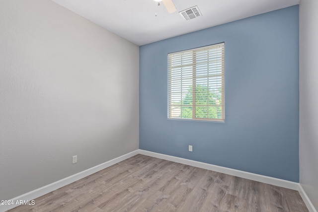 empty room with ceiling fan and light wood-type flooring