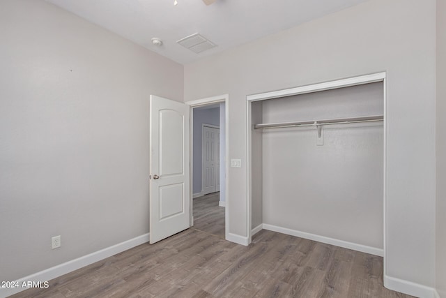 unfurnished bedroom with light hardwood / wood-style floors and a closet