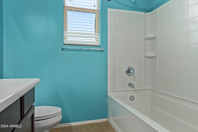 full bathroom featuring tile patterned flooring, vanity, toilet, and tiled shower / bath combo