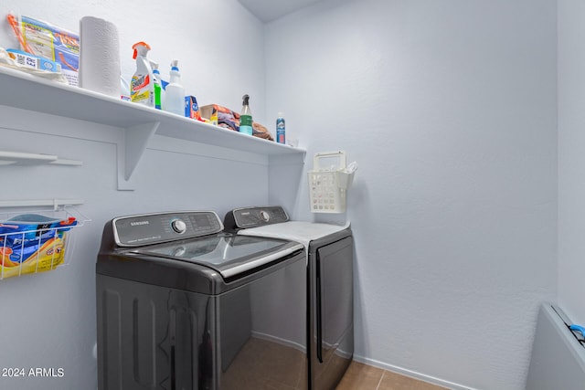 clothes washing area featuring separate washer and dryer and light tile patterned floors