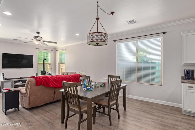 dining space featuring ceiling fan, light hardwood / wood-style floors, and ornamental molding