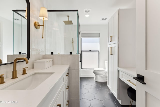 bathroom with tile patterned floors, vanity, walk in shower, and toilet