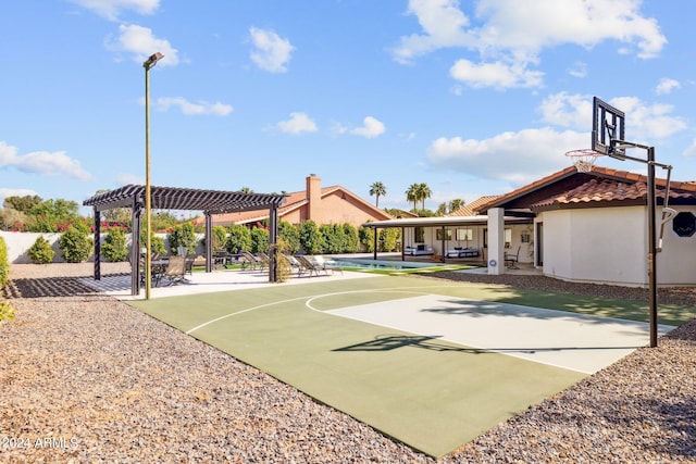 view of basketball court featuring a pool and a pergola