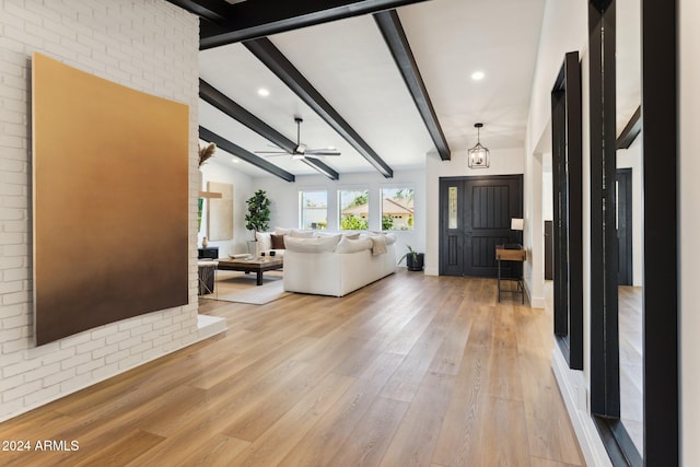 entrance foyer with vaulted ceiling with beams, light hardwood / wood-style flooring, and ceiling fan