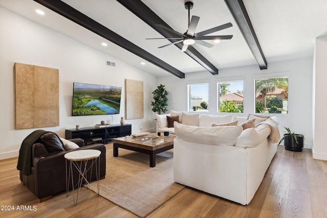 living room featuring ceiling fan, lofted ceiling with beams, and light hardwood / wood-style floors